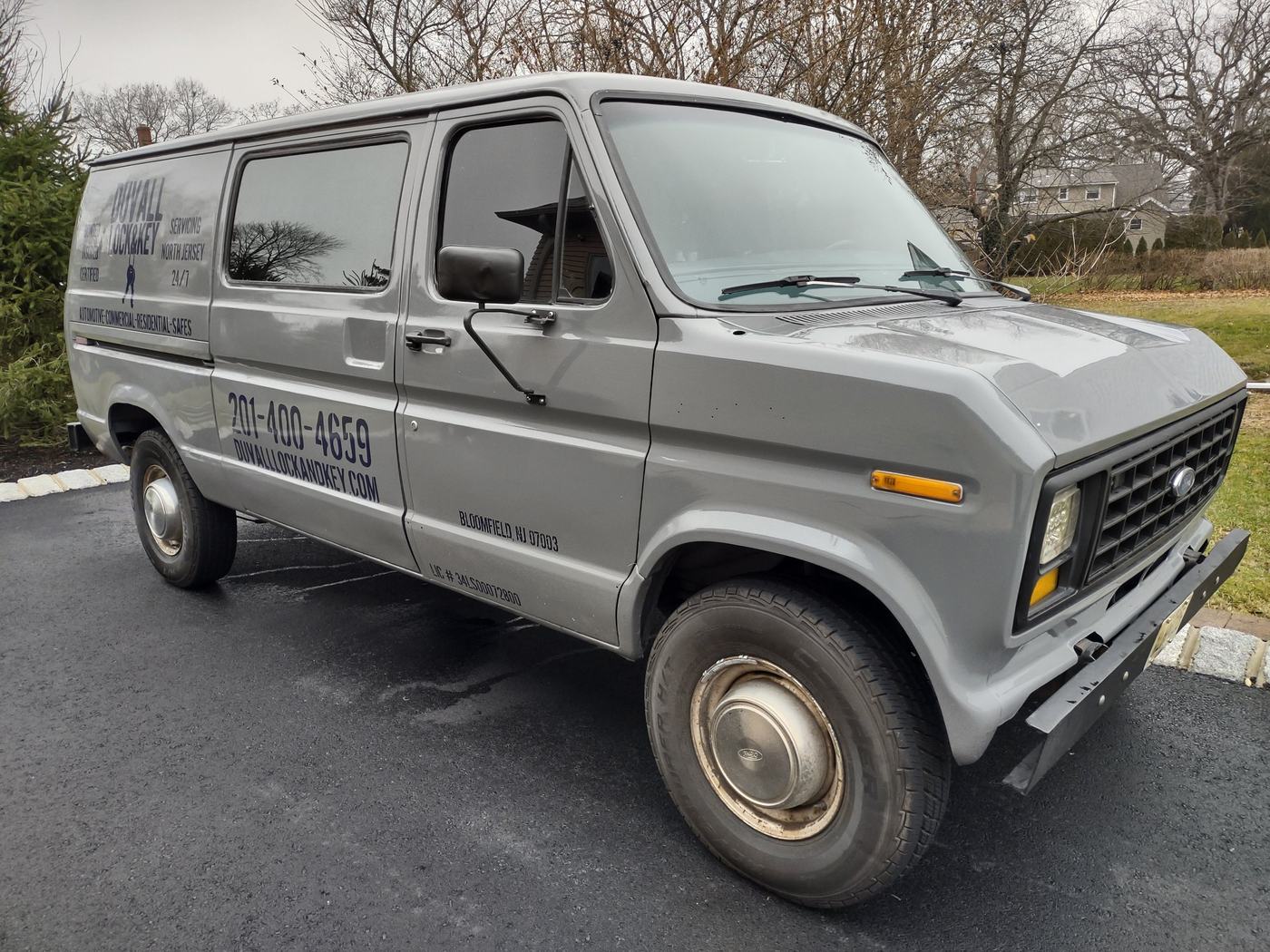 Duvall Lock and Key's gray Ford service van, lettered with the phone number and website